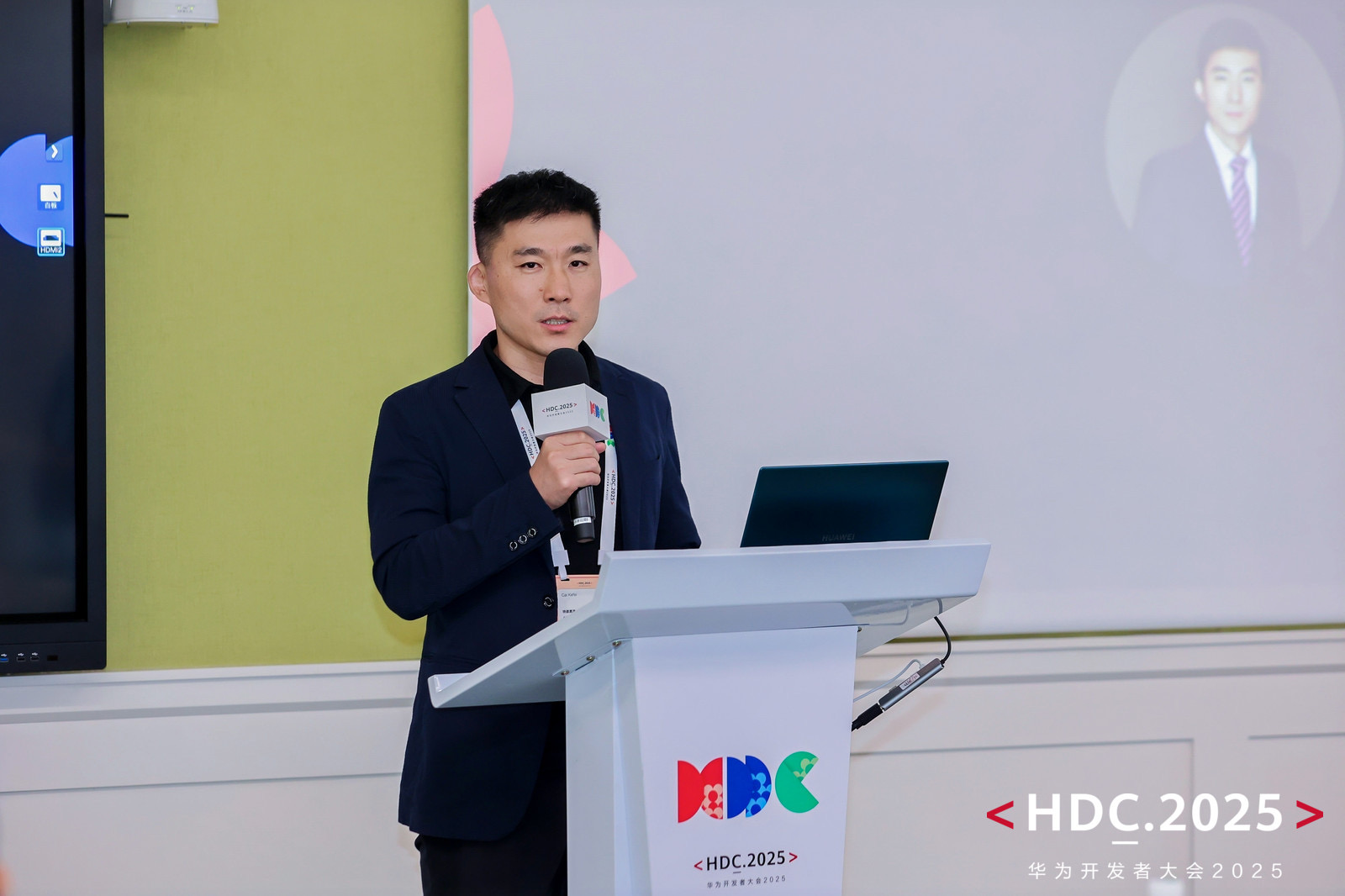 Aonax founder speaking at HDC.2025 with the event backdrop